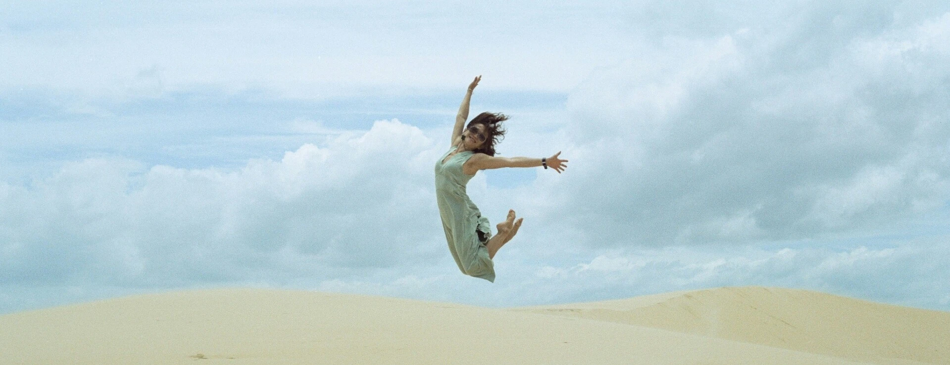 Woman jumps into the air in the desert