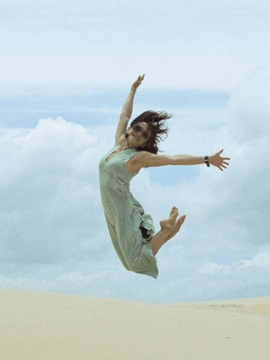 Woman jumps into the air in the desert